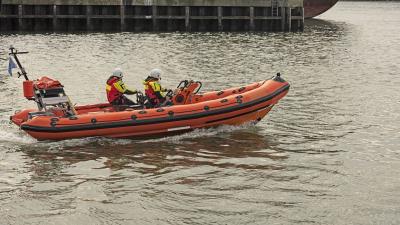 two rescue workers on board orange boat